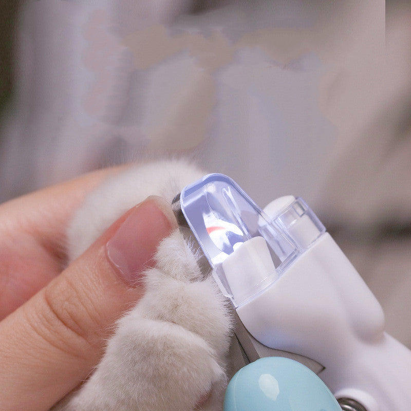 LED pet nail clippers being used carefully on a cat paw