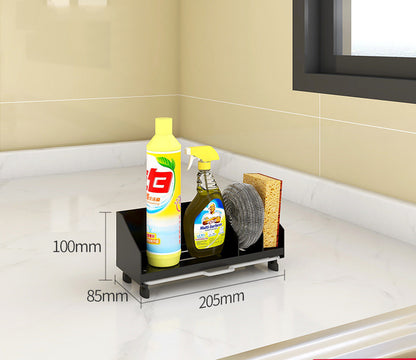 Black metal kitchen sink caddy on a countertop holding dish soap, a spray bottle and sponges; supplies not included.