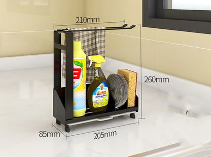 Black metal sink organizer on a countertop with cleaning supplies and its dimensions marked; supplies not included.