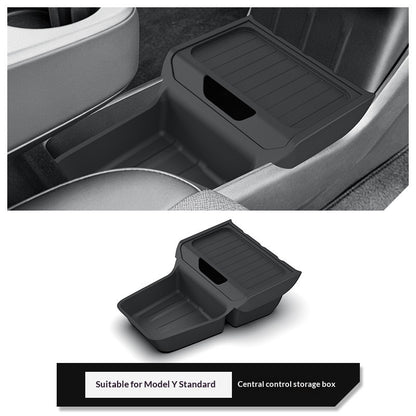 Black plastic storage box fitted into a car's center console to organize everyday items; car interior not included.
