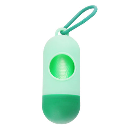 Green plastic dog waste bag holder with a roll of green bags loaded inside, shown on a white background.