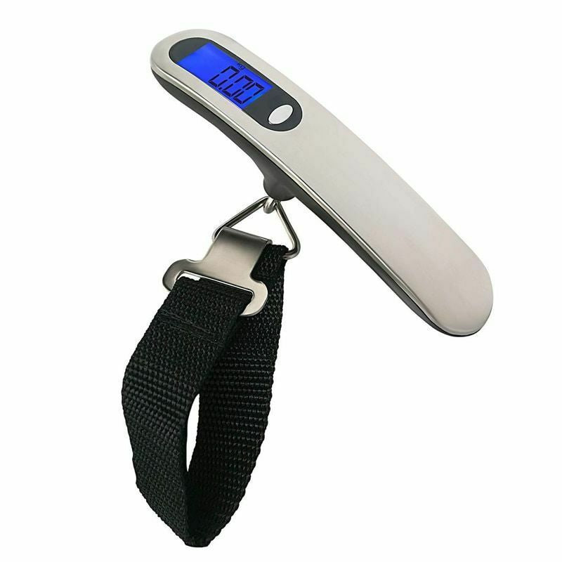 Silver and black handheld digital luggage scale photographed against a plain white background for travel packing.