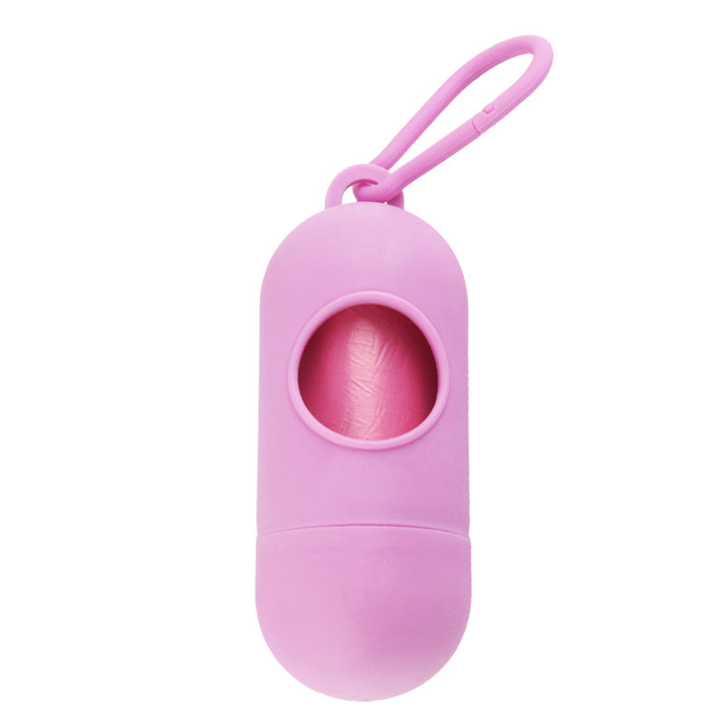 Pink silicone dog waste bag holder with a roll of pink bags inside, shown on a plain white background.