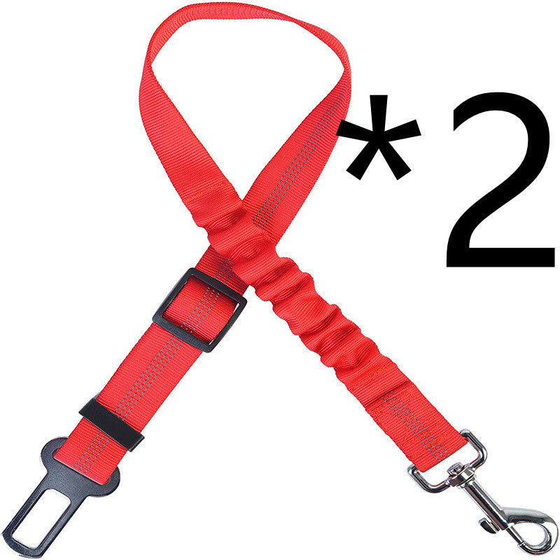 Red nylon dog car seat belt tether with metal and plastic hardware laid flat on a plain white background.