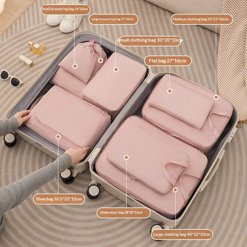 Pink fabric packing cubes arranged inside an open suitcase for organised travel packing; suitcase and shoes not included.