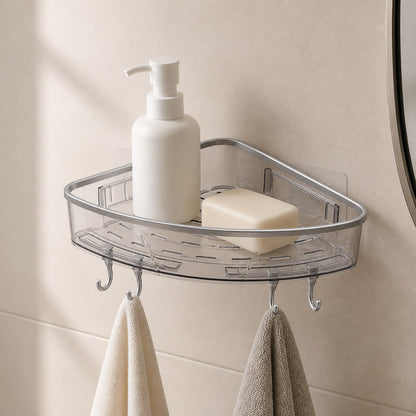 Transparent corner bathroom shelf with a blank bottle, soap bar and cloths hanging from its hooks on a tiled wall