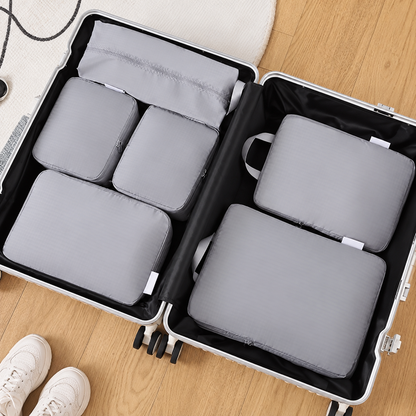 Six gray packing organizers in a suitcase, cleaned supplier scene. Suitcase and shoes not included.