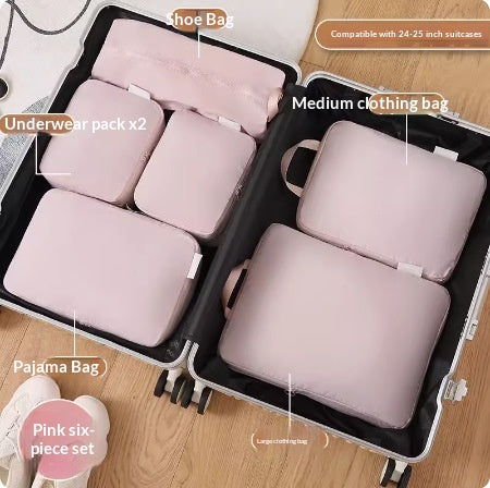 Pink nylon packing cubes packed into an open suitcase on the floor before a trip; suitcase and shoes not included.
