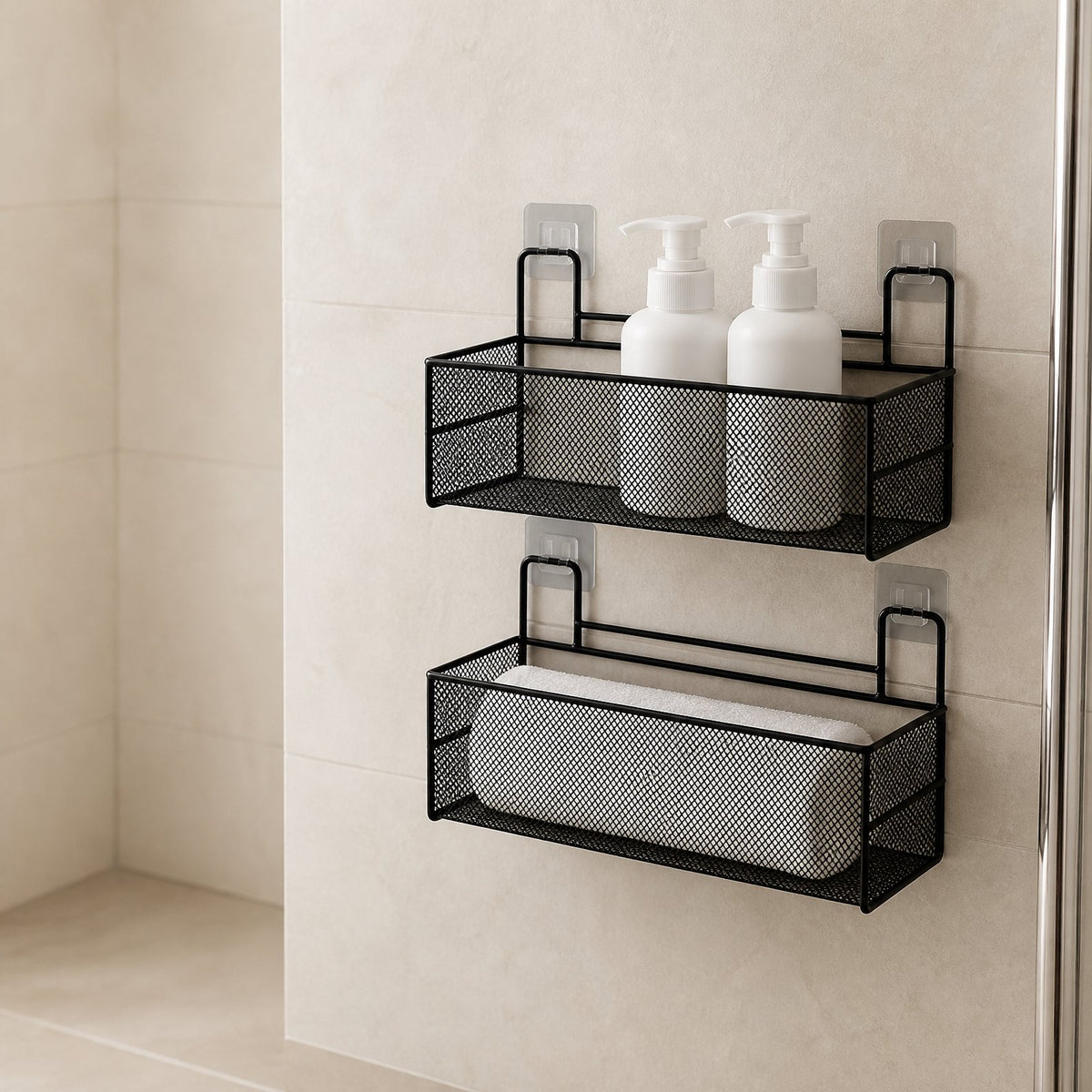 Two-tier black wire mesh bathroom shelf with unbranded bottles and a rolled towel on a tiled wall