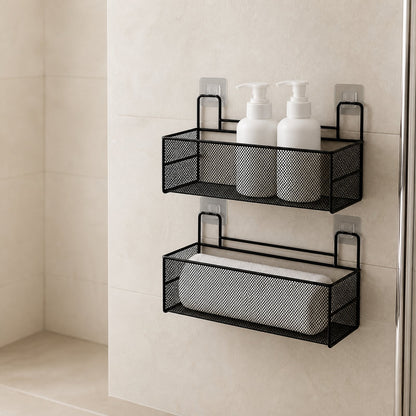 Two-tier black wire mesh bathroom shelf with unbranded bottles and a rolled towel on a tiled wall