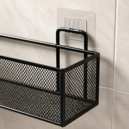 Close-up of the shower shelf's wire frame, mesh side panel and clear adhesive wall mount