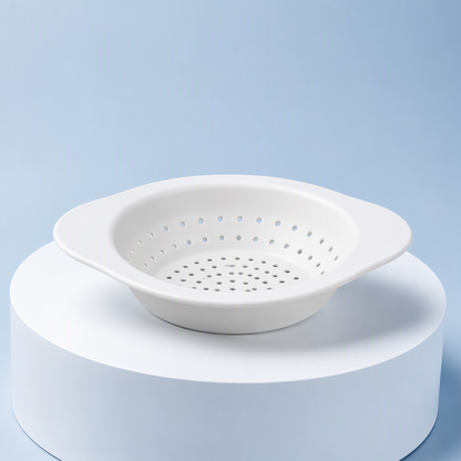Flexible white sink strainer with perforated basket and side tabs